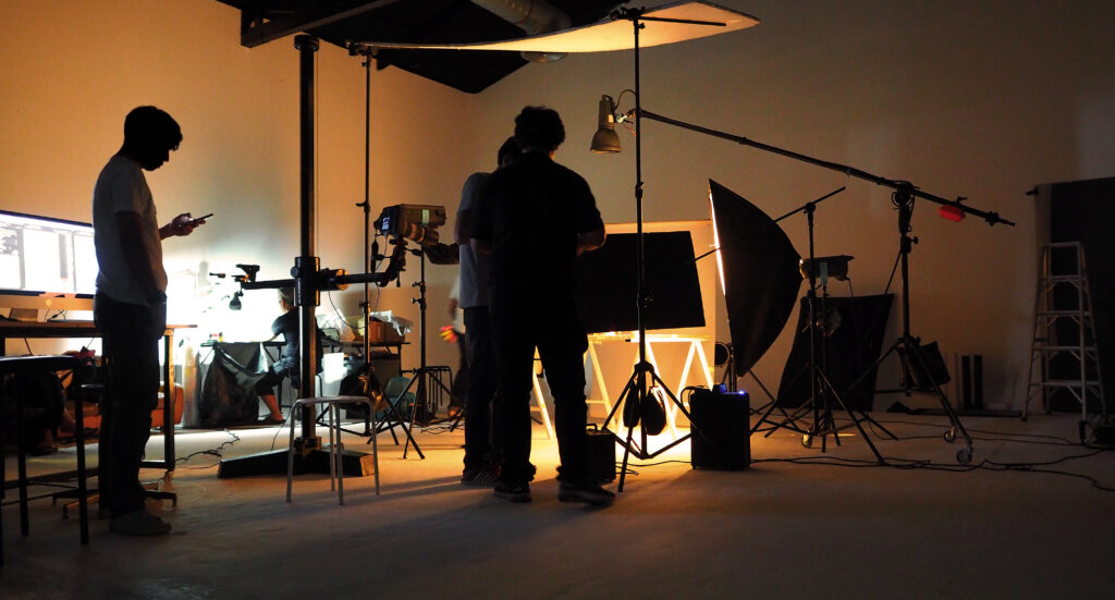 ECG Productions team working in a controlled studio production setup.