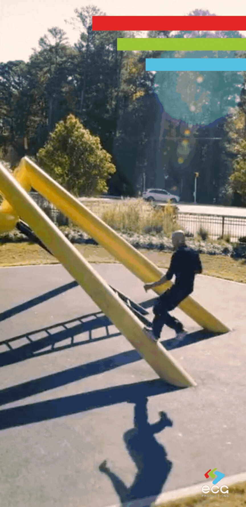 Aerial shot captures a stuntman running up a playground structure, leaping off as it transitions into a VFX shot where the playground morphs into a monster chasing him toward a manhole, showcasing the creative blend of drone video and aerial photography with VFX.